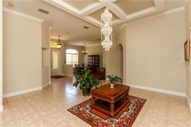 Formal living room features tile floors, trey ceil