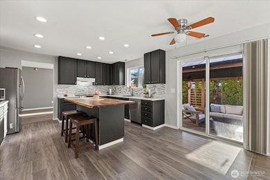 The kitchen has a layout that flows effortlessly with room for seating at the island and enough room for a dining table!