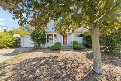 Obstructed view of property featuring asphalt driveway and a garage