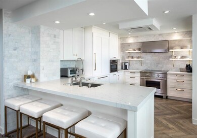 Quartz-topped peninsula offers bonus seating. Indu