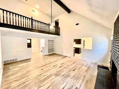 Unfurnished living room with beam ceiling, built i