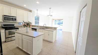 Kitchen featuring light tile patterned floors, a s