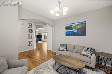 Living room with hardwood / wood-style flooring an