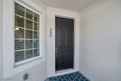 Doorway to property featuring stucco siding