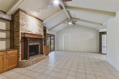 Great Room with wood burning fireplace. Kitchen to