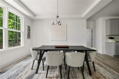 Dining room featuring a notable chandelier, hardwo