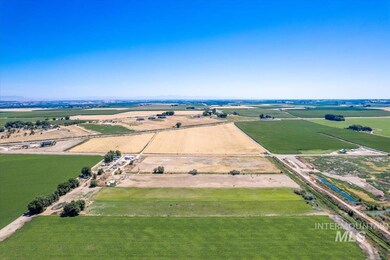 Aerial view of sparsely populated area featuring large plots for crops
