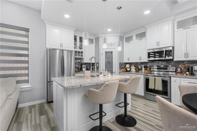 Kitchen with glass insert cabinets, appliances with stainless steel finishes, backsplash, wood finish floors, and recessed lighting
