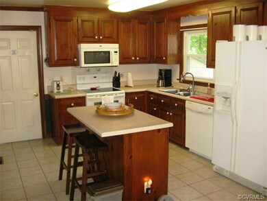 Hardwood Cabinets and Ceramic Tile Complete this L