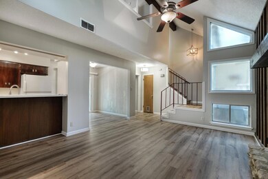 Unfurnished living room featuring high vaulted ce