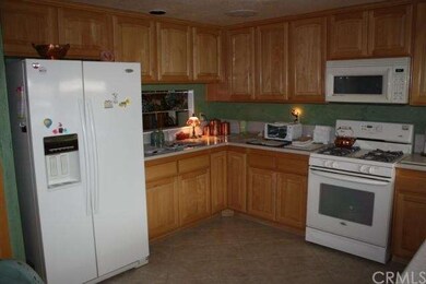 Remodeled kitchen has recessed lighting, newer cou
