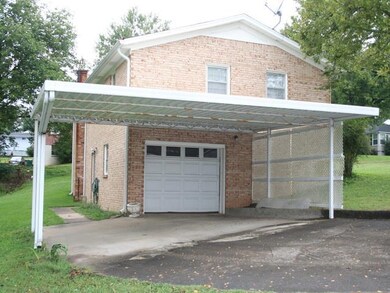 WOW! Double wrought iron carport with 850 sqft concrete drive. 