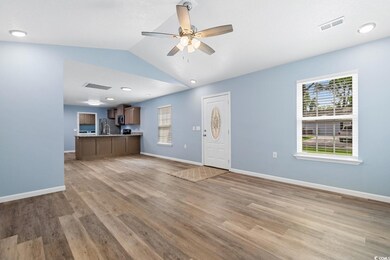 Unfurnished living room featuring vaulted ceiling,