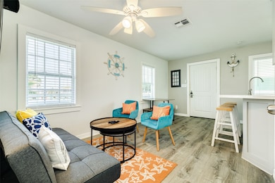 This cozy living space features modern wood floori
