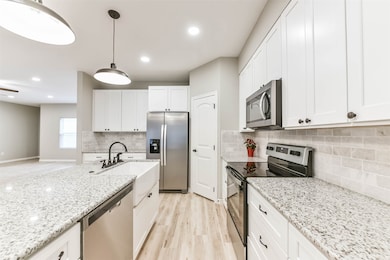 A chef’s dream kitchen with plenty of prep space, modern finishes, and an open view to the living area.