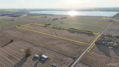 Aerial view of sparsely populated area with property boundaries highlighted and a nearby body of water