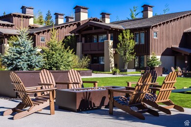 Patio / terrace with a fire pit, a patio area, and a lawn
