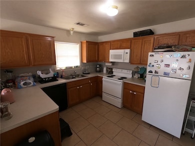 Kitchen with visible vents, light countertops, bro