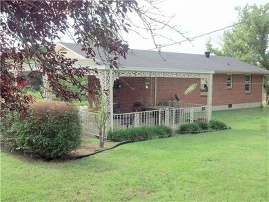 Covered patio area has a wrought iron fence around it