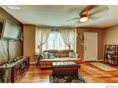 The family room boasts gleaming hardwood floors an