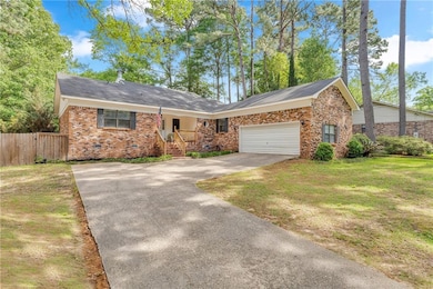 Ranch-style home with fence, a front lawn, concret