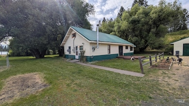 View of home's exterior with a lawn and a metal roof