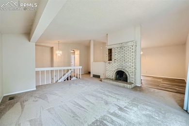 Living Room with fireplace, vaulted ceilings and v