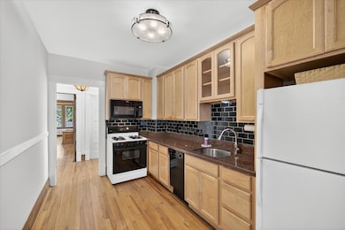 Kitchen was fully remodeled with custom cabinets, new lighting, counter tops and subway backsplash.