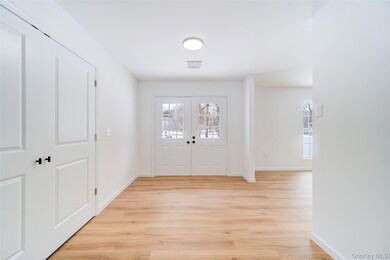 Enterance way showing Double Entry Doors w/closet