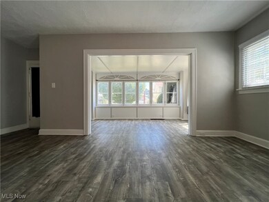 Unfurnished room featuring dark hardwood / wood-style floors and a textured ceiling