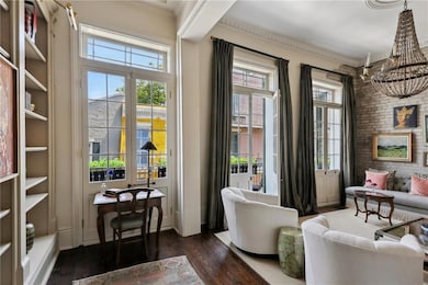 Three sets of French doors open to balcony