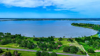 Birds eye view of property with a water view