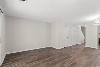 Spare room featuring a textured ceiling and dark w