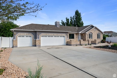 Ranch-style house with a shingled roof, concrete driveway, brick siding, an attached garage, and a chimney