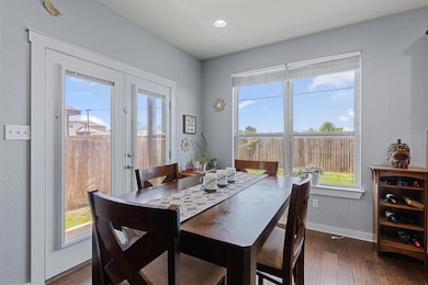 Dining space with dark wood-type flooring, french