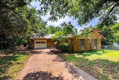 Ranch-style home with driveway, an attached garag