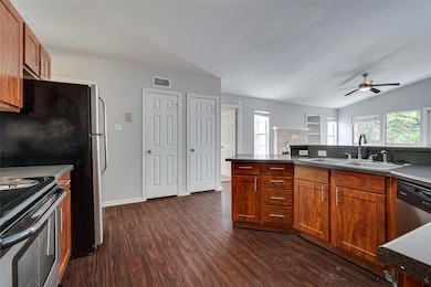 Kitchen with a sink, dark wood-style floors, rang