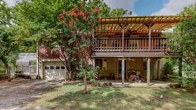 The home features a one car garage, large covered deck and greenhouse space.