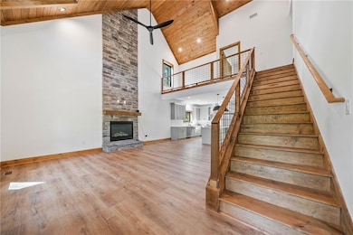 Stairway featuring high vaulted ceiling, a ceiling
