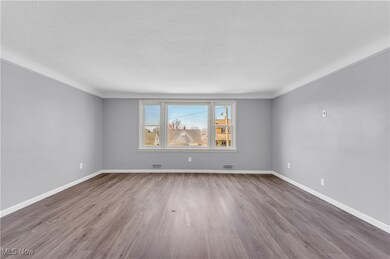 Spare room with visible vents, baseboards, wood finished floors, and a textured ceiling