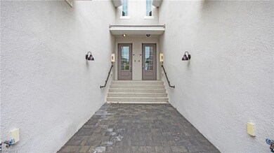 Entrance to property featuring stucco siding