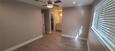 Unfurnished room featuring ceiling fan, baseboard
