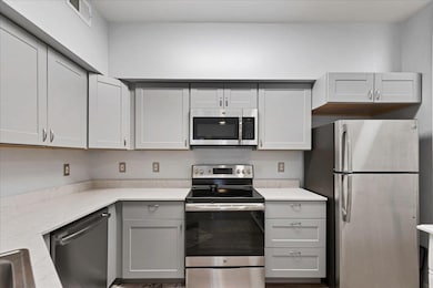 Kitchen featuring appliances with stainless steel