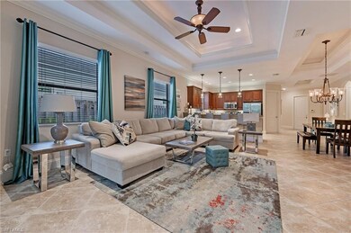 Great Room with a raised ceiling, crown molding, a