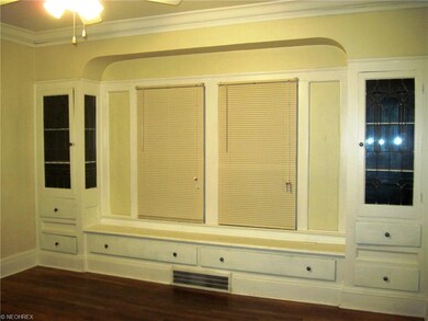 First floor dining room with leaded glass cabinets and hardwood floors.