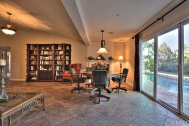 Living Room has Granite Fireplace and Sliding Door