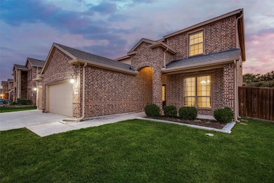 View of front of property featuring brick siding, driveway, an attached garage, and roof with shingles