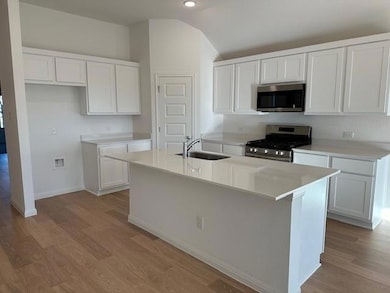Kitchen with stainless steel appliances, a sink, 