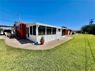 Rear view of property featuring a yard and a patio