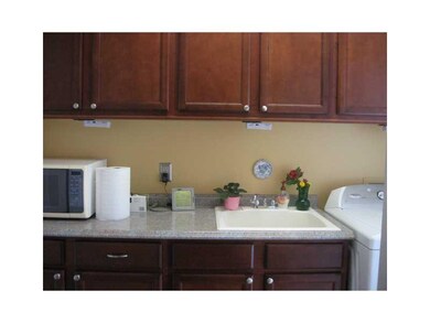 Other. First floor laundry with cherry cabinetry v